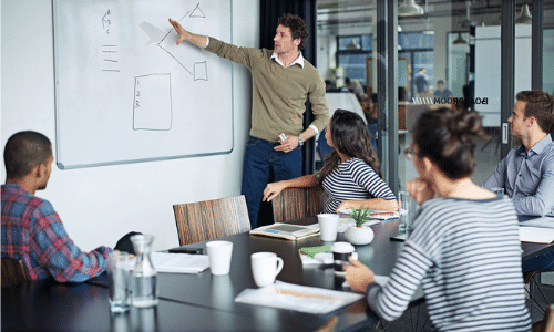 Project leader pointing to whiteboard