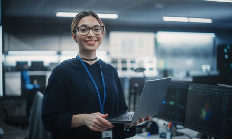 Cybersecurity expert holding a laptop.