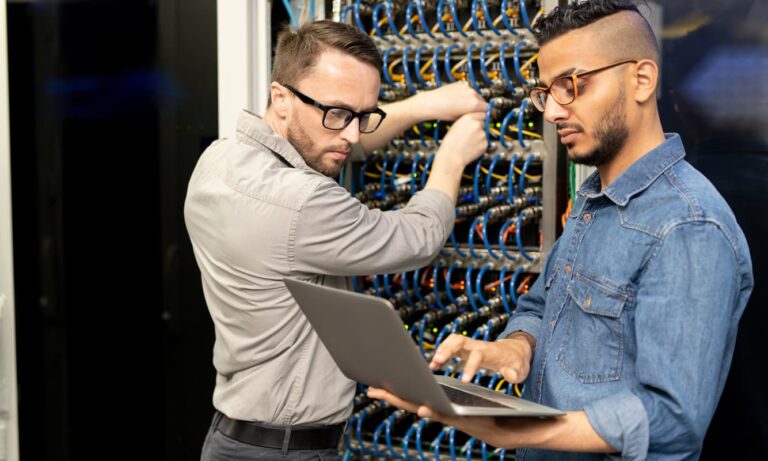 Managed Services vs. In-House IT concept photo: IT professionals conducting proactive server maintenance.