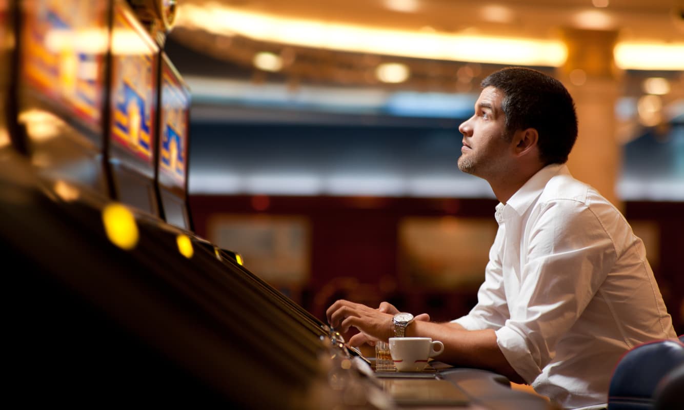 Casino guest playing a game on a modern AI-powered slot machine