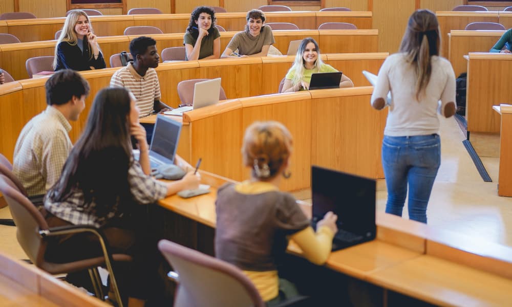 College professor delivering a lecture to students in a lecture room.