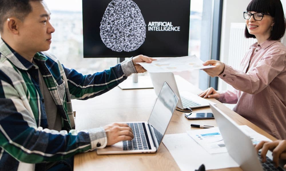 Team members collaborating on an artificial intelligence project in a modern office environment.