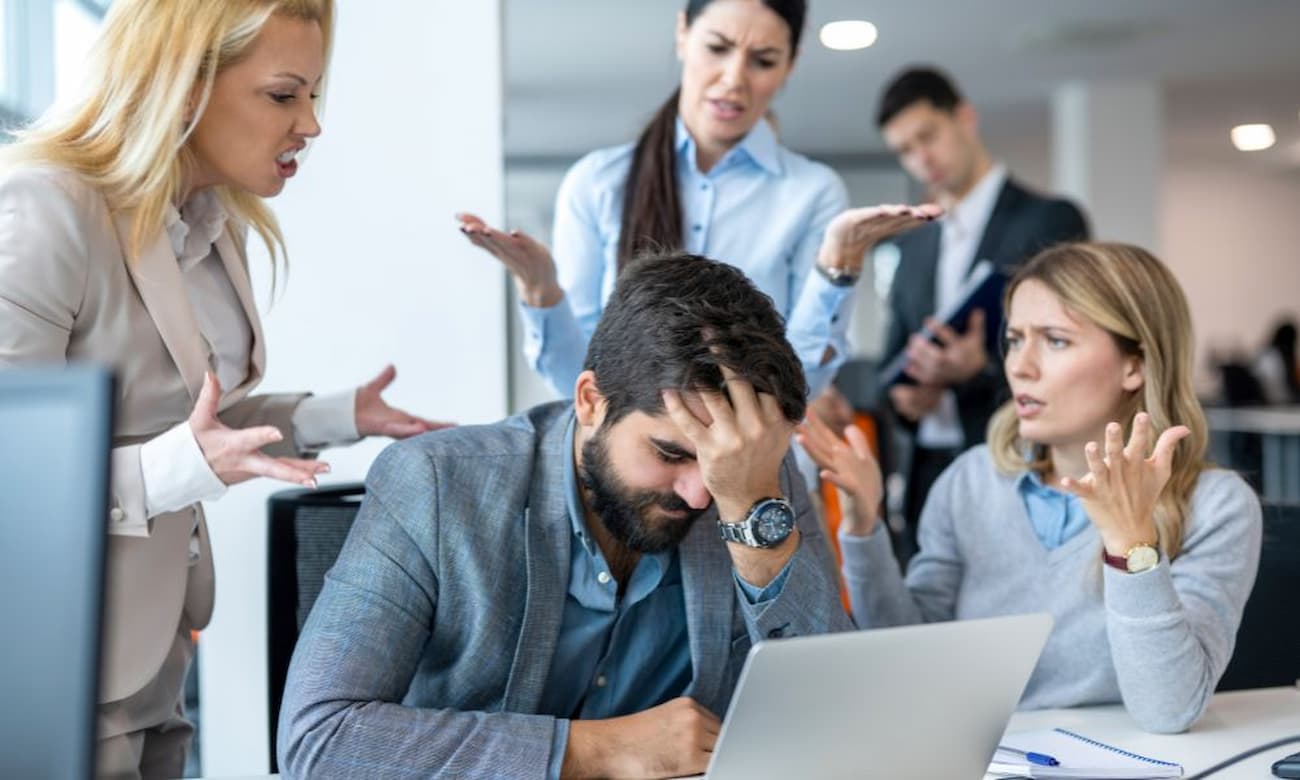 IT professionals reviewing a project while showing signs of frustration