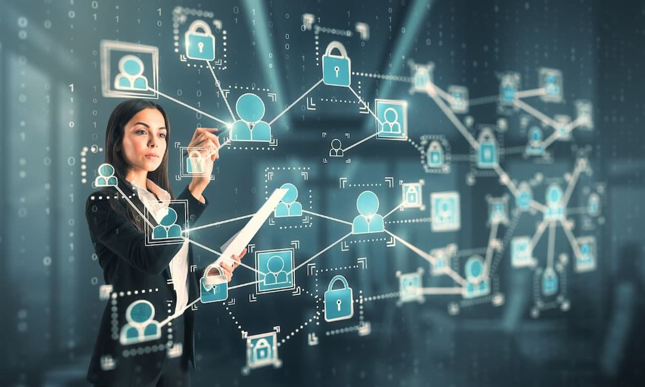 A young woman works on a chart of computer system permission structures.