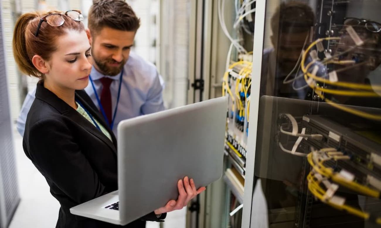 Network engineers working on servers at a data center