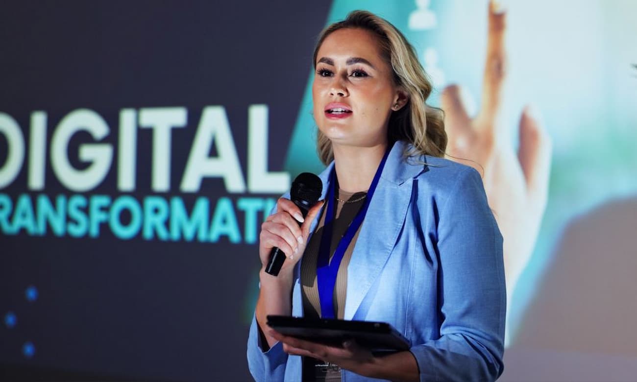 Female speaker speaking at a corporate event about digital transformation