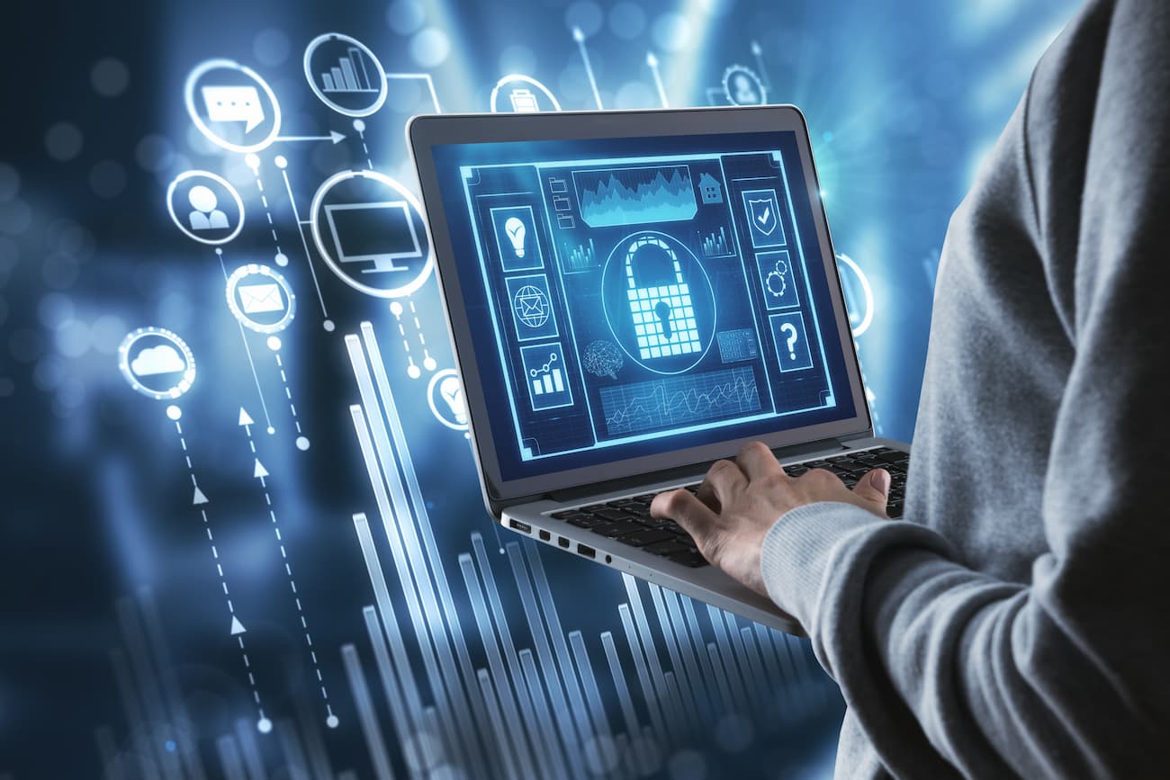 A person types on a laptop displaying a security interface. A digital, blue background contains various white icons of networking and cybersecurity elements.