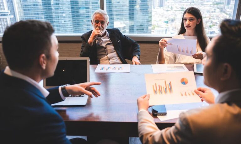 Business professionals reviewing information together during a meeting.