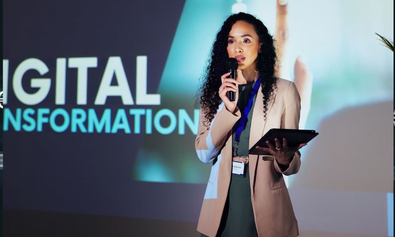 Female speaker speaking at corporate event about digital transformation